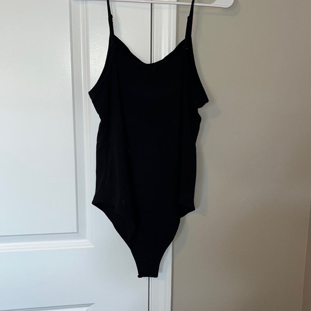 XL body suite. Snaps located near the bottom half.